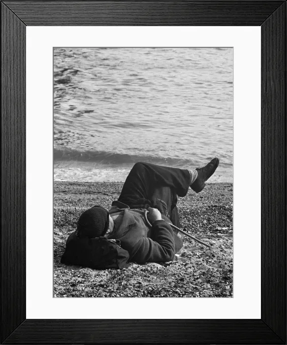 Framed Print : A day-tripper from Londons East End, relaxes in the summer sunshine on the beach Framed Print : A day-tripper from Londons East End, relaxes in the summer sunshine on the beach