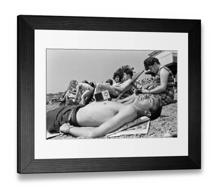 Framed Print : A family of day trippers from London, soaking up the summer sun whilst listening to music
