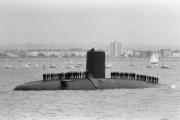 A submarine crew line the decks as they await the Britannia