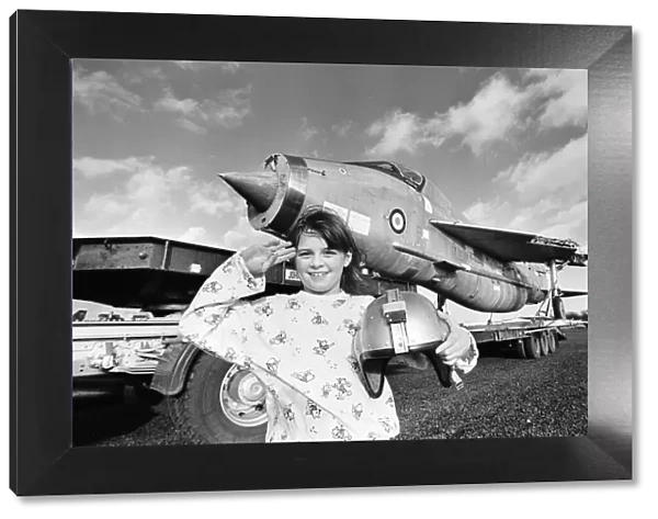 Eight year old Cheryl James poses beside a T55 Lightning fighter jet