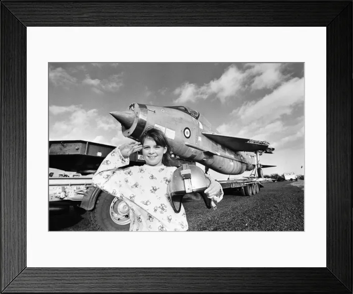 Framed Print : Eight year old Cheryl James poses beside a T55 Lightning fighter jet Framed Print : Eight year old Cheryl James poses beside a T55 Lightning fighter jet