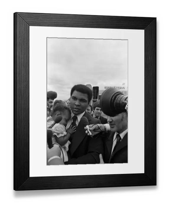 Framed Print : Muhammad Ali arrives at Teesside Airport with his family. July 1977 Framed Print : Muhammad Ali arrives at Teesside Airport with his family. July 1977