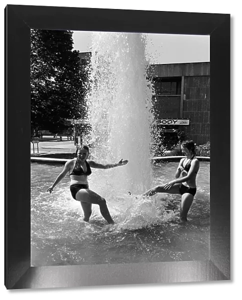 Two girls cooling off in the Belgrade Fountain, Coventry. 3rd July 1976