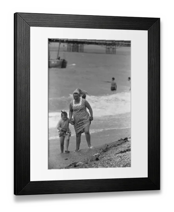Framed Print : Holiday scenes at Brighton Mother and daughter paddling in the English channel Framed Print : Holiday scenes at Brighton Mother and daughter paddling in the English channel