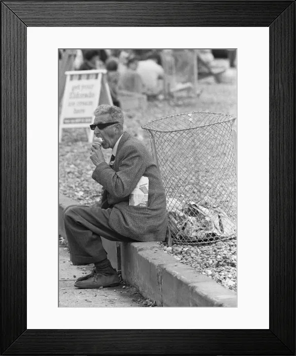 Framed Print : Holiday scenes at Brighton Elderly holidaymaker seen here enjoying an ice cream to