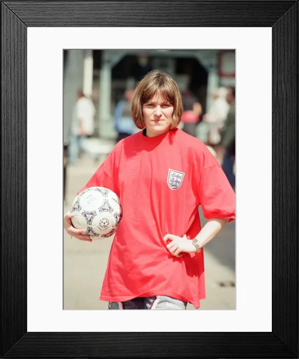 Framed Print : Shop asistant Karen Burke from Soccer City, models Englands old Red Strip, Liverpool