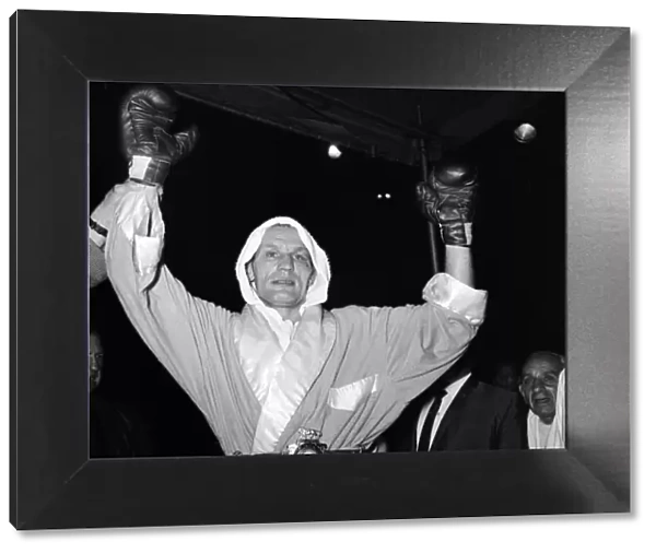 Henry Cooper jubilantly shows his Lonsdale belt after his boxing triumph over Johnny