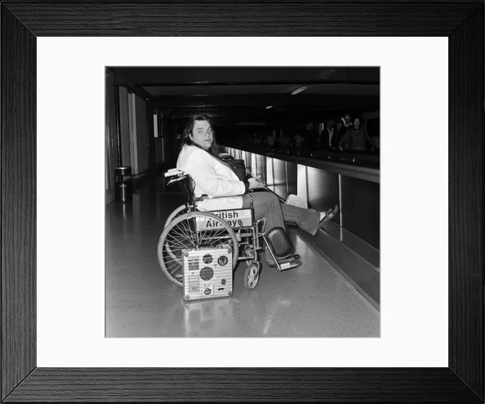 Framed Print : Pop singer Meat Loaf leaving Heathrow Airport in a wheelchair. 23rd June 1985 Framed Print : Pop singer Meat Loaf leaving Heathrow Airport in a wheelchair. 23rd June 1985
