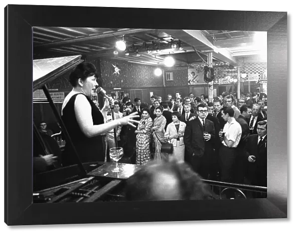 Cabaret singer performing in a East End of London pub on a Saturday night. 6th July 1963