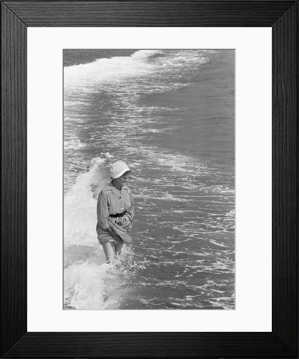 Framed Print : Holiday scenes at Brighton Elderly woman paddling in the sea holding her skirt up Framed Print : Holiday scenes at Brighton Elderly woman paddling in the sea holding her skirt up