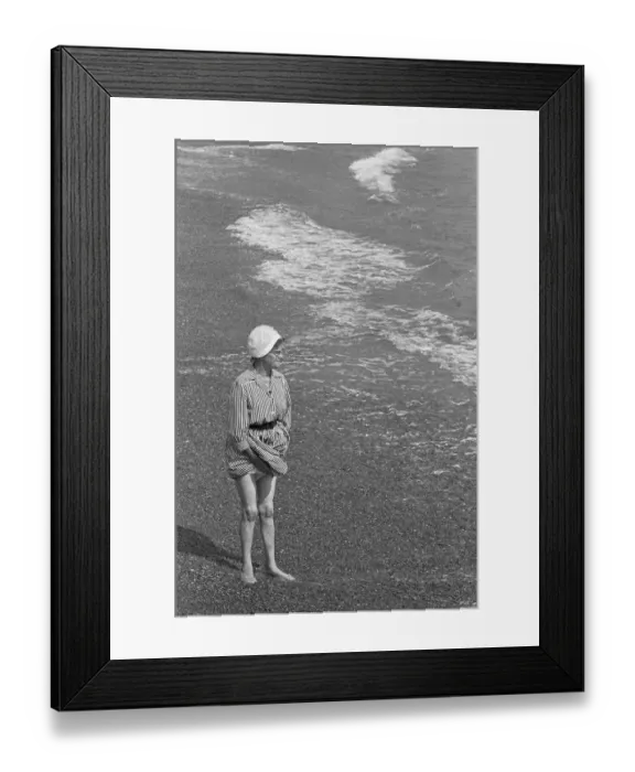 Framed Print : Holiday scenes at Brighton Elderly woman paddling in the sea holding her skirt up Framed Print : Holiday scenes at Brighton Elderly woman paddling in the sea holding her skirt up