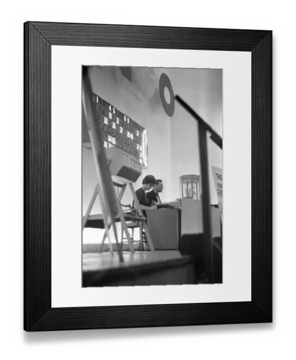 Framed Print : The bingo number caller sit on the stage of the Gaiety Theatre, Cardiff. 31st July 1963 Framed Print : The bingo number caller sit on the stage of the Gaiety Theatre, Cardiff. 31st July 1963