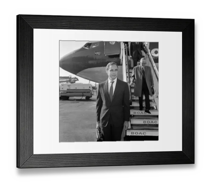 Framed Print : Marlon Brando arrives at Heathrow Airport in London, to take part in a television