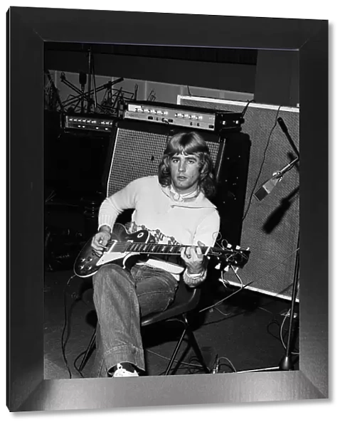 Rick Parfitt, lead guitar in the rock group Status Quo, rehearses in the studio