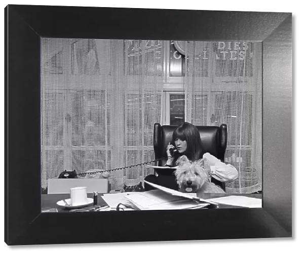Cathy McGowan, English Television Personality, pictured in her office with her dog