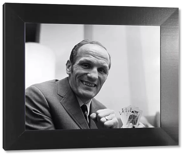 Henry Cooper holding four kings, relaxing playing cards in a Hampstead hotel