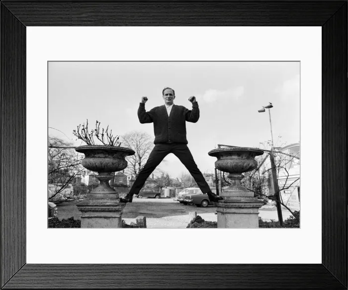Framed Print : Henry Cooper, pictured standing astride two ornamental flower pots in the garden of Framed Print : Henry Cooper, pictured standing astride two ornamental flower pots in the garden of