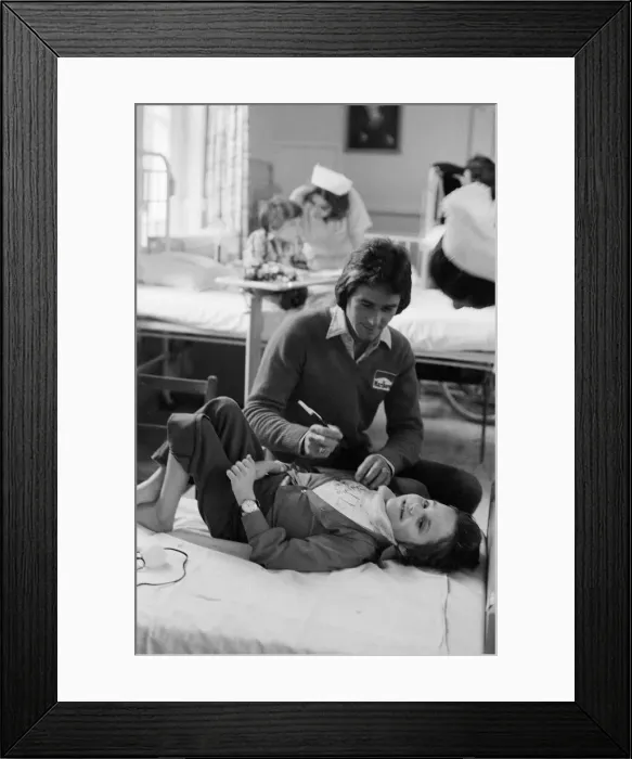 Framed Print : British Motorcycle road racer Barry Sheene with young fan Tony Vickers who is undergoing Framed Print : British Motorcycle road racer Barry Sheene with young fan Tony Vickers who is undergoing