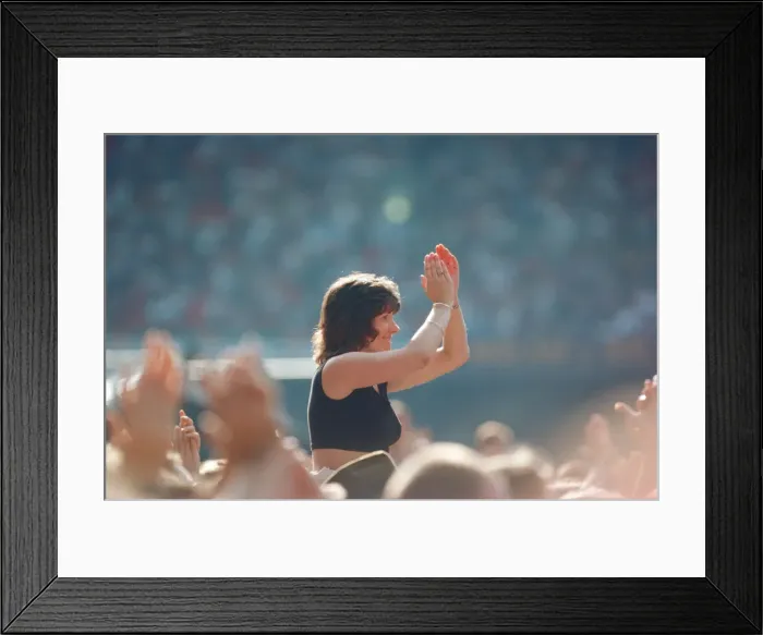 Framed Print : A lady aloft and enjoying the day, part of the huge audience watch American Rock Group