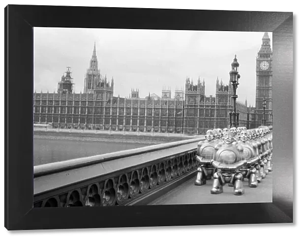 Robots lined up over Westminster Bridge. The robots were supplied by EMI Records who used