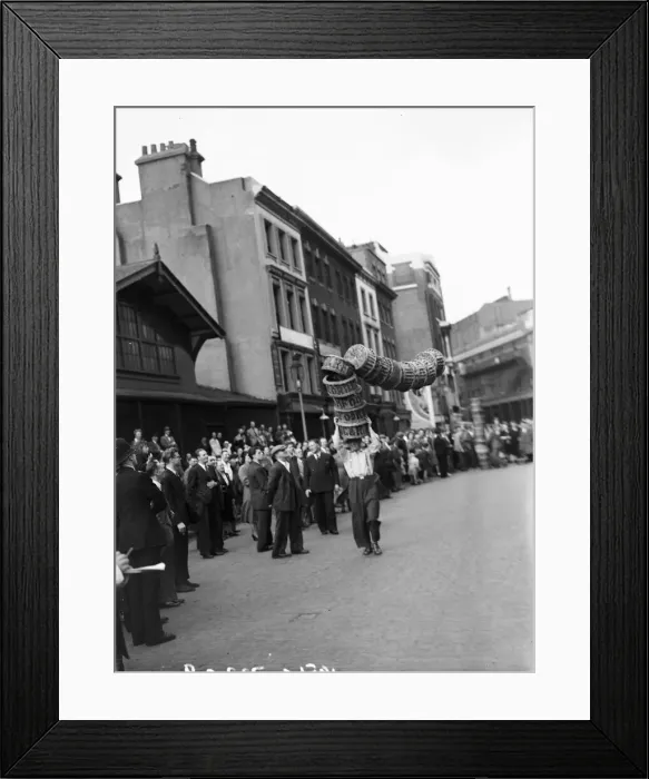 Framed Print : Porters from Covent Garden Flower and Vegetable market race with baskets stacked on their Framed Print : Porters from Covent Garden Flower and Vegetable market race with baskets stacked on their
