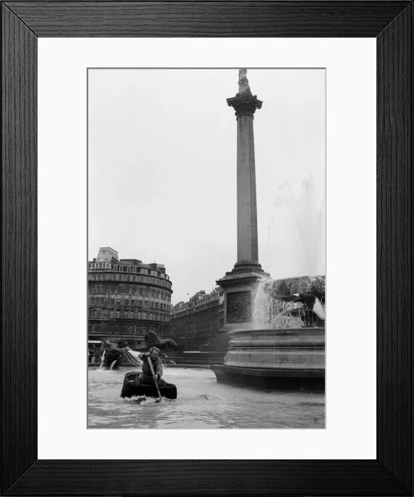 Framed Print : Coracle fishermen in London. One of the fishermen paddles his coracle round Trafalgar Framed Print : Coracle fishermen in London. One of the fishermen paddles his coracle round Trafalgar
