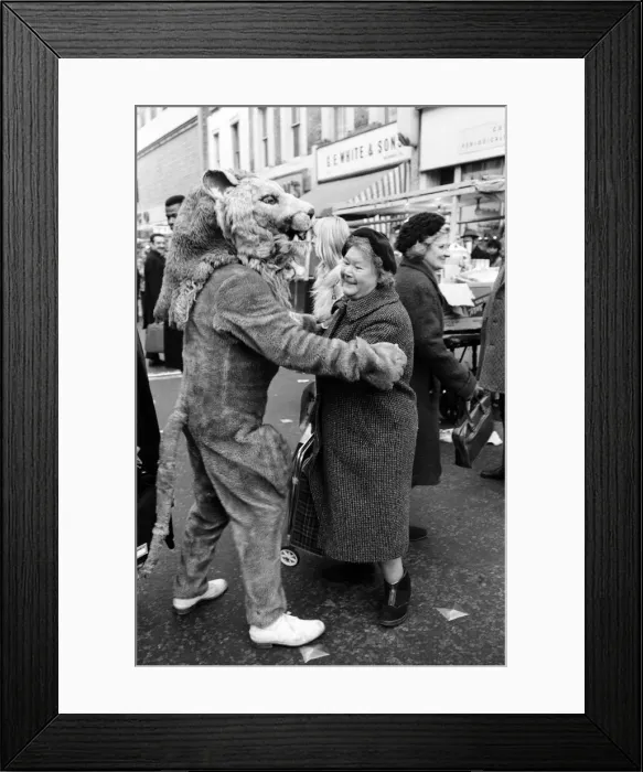 Framed Print : The circus visits Portobello Road, London. Mrs Lucie McClelland gets involved in a dance Framed Print : The circus visits Portobello Road, London. Mrs Lucie McClelland gets involved in a dance