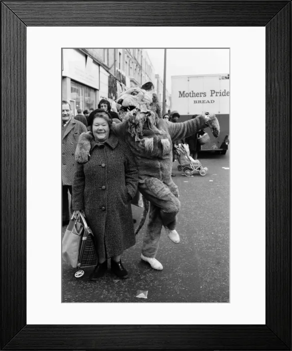 Framed Print : The circus visits Portobello Road, London. Mrs Lucie McClelland gets involved in a dance Framed Print : The circus visits Portobello Road, London. Mrs Lucie McClelland gets involved in a dance