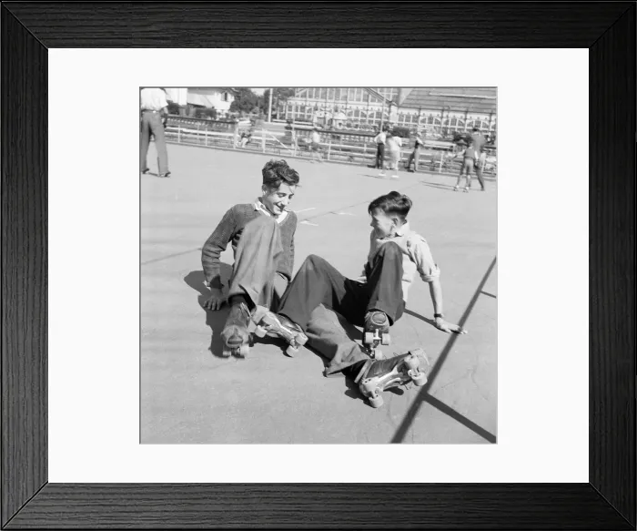 Framed Print : Two boys having a little trouble getting to their feet after a fall at the Winter Garden