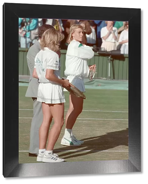 Steffi Graf pictured holding her winners trophy, and Martina Navratilova with her runners