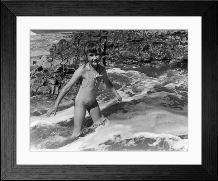 Framed Print : Laura Pearce 8 from Caerphilly, plays in the waves at she enjoys the sun at Ogmore by Sea Framed Print : Laura Pearce 8 from Caerphilly, plays in the waves at she enjoys the sun at Ogmore by Sea