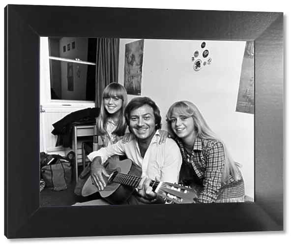 Des O Connor playing guitar at home with his daughters Samantha and Tracy