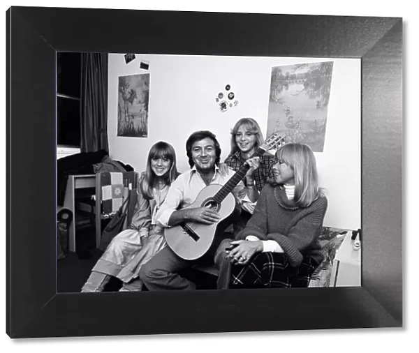 Des O Connor playing guitar at home with his daughters Tracy and Samantha