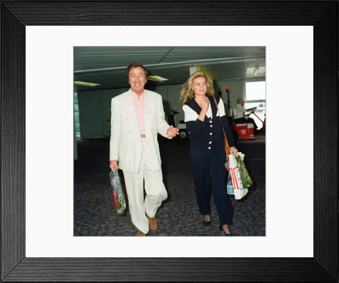 Framed Print : Des O Connor and girlfriend Jodie Brooke Wilson and Heathrow Airport Framed Print : Des O Connor and girlfriend Jodie Brooke Wilson and Heathrow Airport