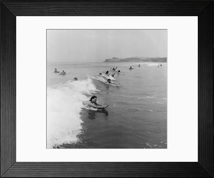 Framed Print : When the foaming waves break with a roar, bathers throw themselves forward onto their