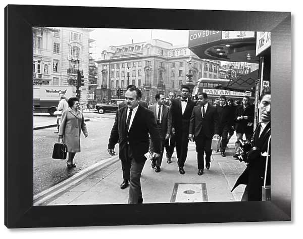 Cassius Clay (centre) and entourage walking down Charing Cross Road on route to his press
