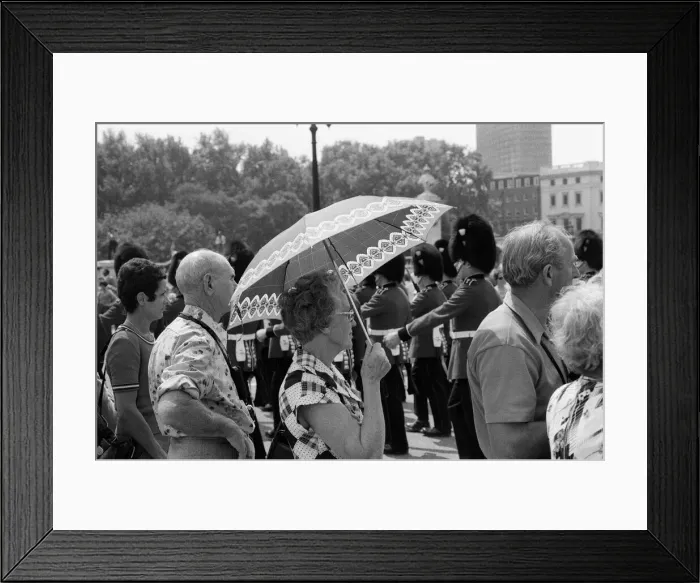 Framed Print : Changing of the Guard in London today. An umbrella serves as a sun-shade for a spectator Framed Print : Changing of the Guard in London today. An umbrella serves as a sun-shade for a spectator