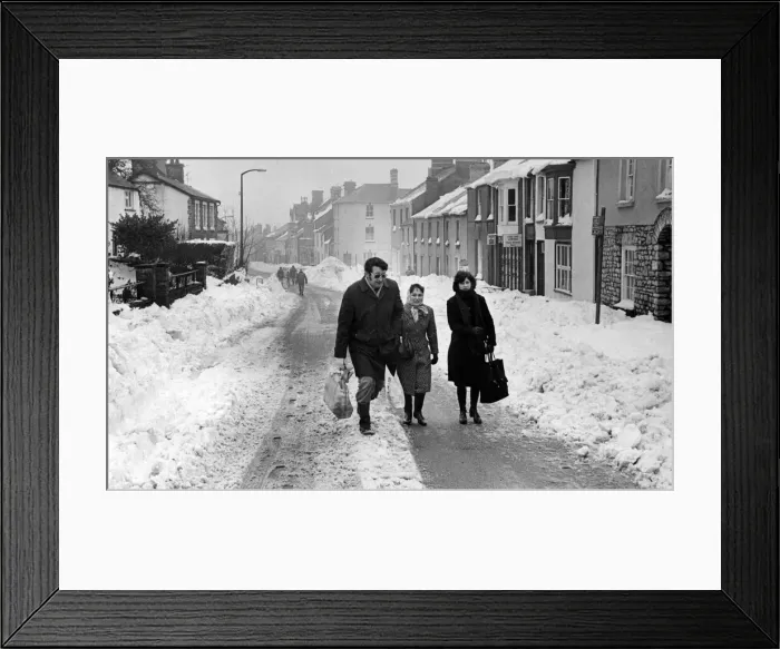 Framed Print : Pedestrians make their way along the main street of Cowbridge after the road had at last