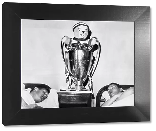 Two Celtic players have a well earned sleep with their European Cup trophy