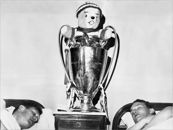 Two Celtic players have a well earned sleep with their European Cup trophy
