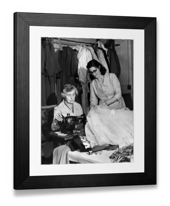 Framed Print : Miss Marion Agar, wardrobe mistress (right) helps Mrs May Finch, the dressmaker