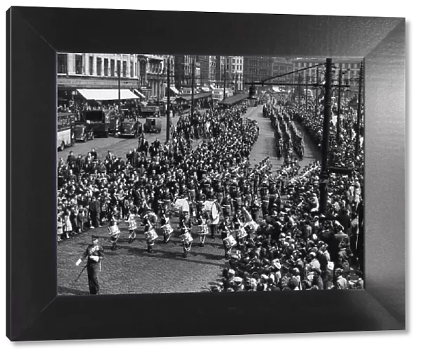 The Manchester Regiment led by the band seen here marching pass Piccadilly Gardens