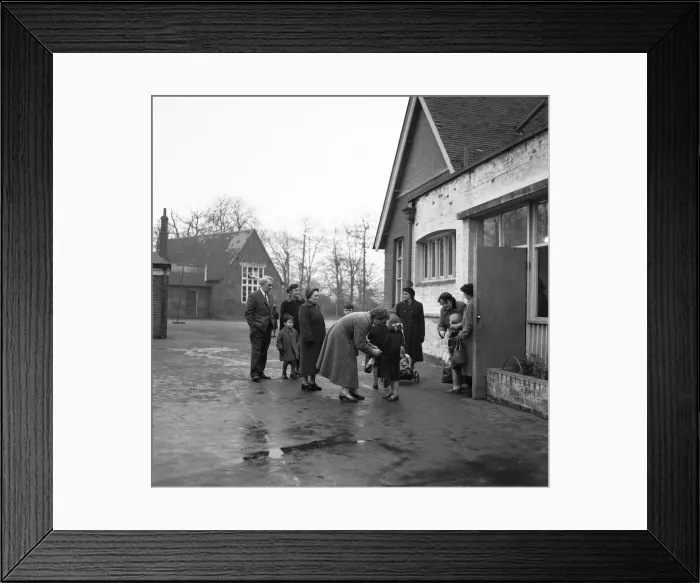 Framed Print : Parents collecting their children from school. 6th December 1957 Framed Print : Parents collecting their children from school. 6th December 1957