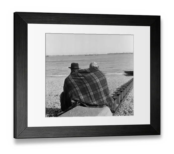 Framed Print : Two visitors to Dover in Kent huddled up on the beach in blankets. 16th April 1954 Framed Print : Two visitors to Dover in Kent huddled up on the beach in blankets. 16th April 1954