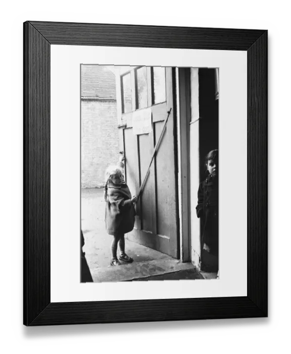 Framed Print : Child closing the door to the classroom following morning break at Roxeth Primary School