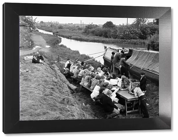 Children of barge familys seen here being educated on the canal bank by a floating