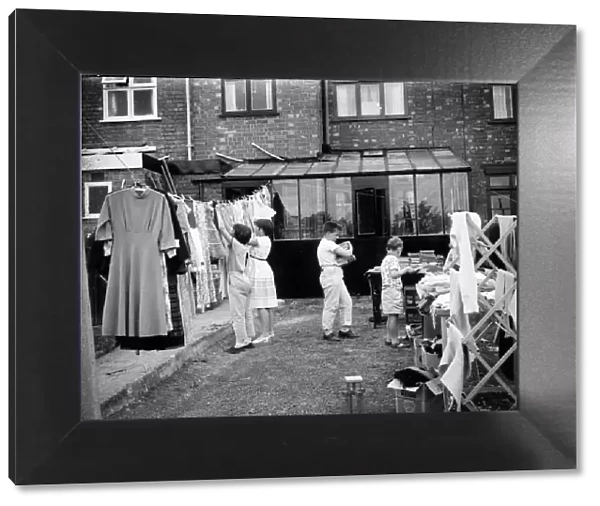 Children clear their bedrooms by having a yard sales in Coventry. Circa 1965