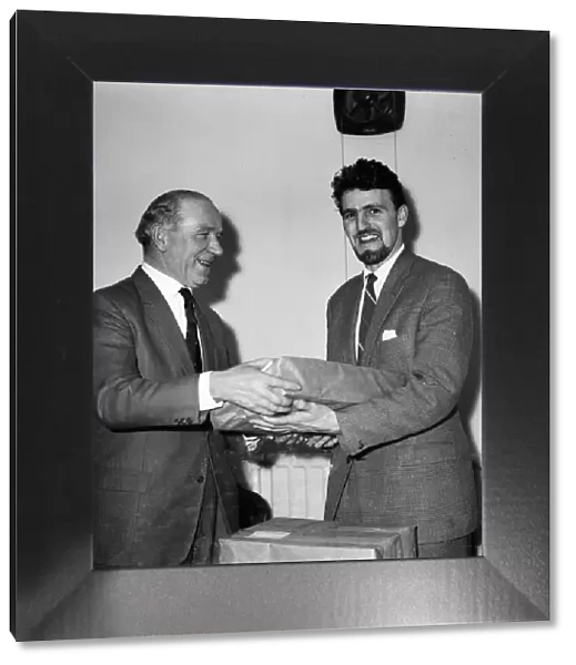 Manchester United manager Matt Busby and Coventry City manager Jimmy Hill exchange gifts