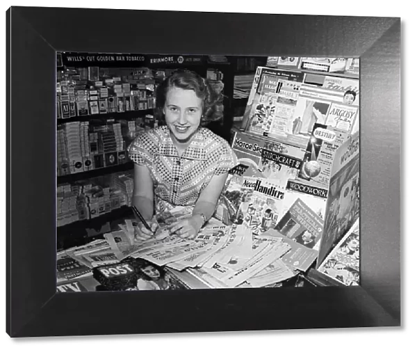 A woman working in a newsagent in Newport, Isle of Wight. 11th August 1955