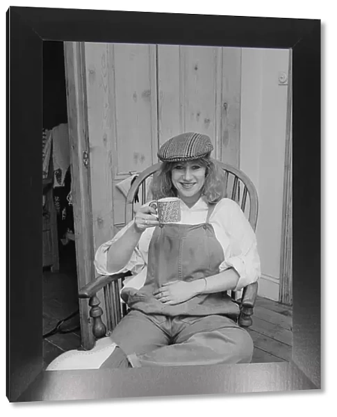 Photo shows Helen Mirren seated in her country Windsor chair wearing her favourite cap